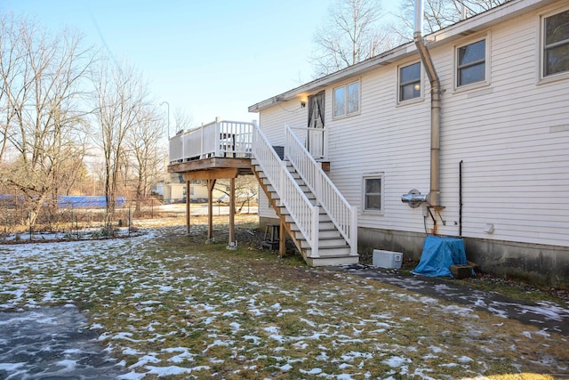 snow covered house with a deck