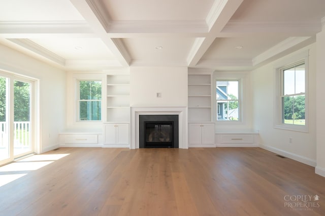 unfurnished living room featuring hardwood / wood-style flooring, ornamental molding, coffered ceiling, and beam ceiling