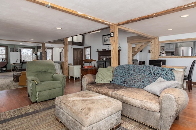 living room featuring hardwood / wood-style floors and beamed ceiling