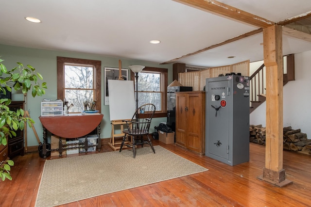 interior space featuring wood-type flooring and beam ceiling