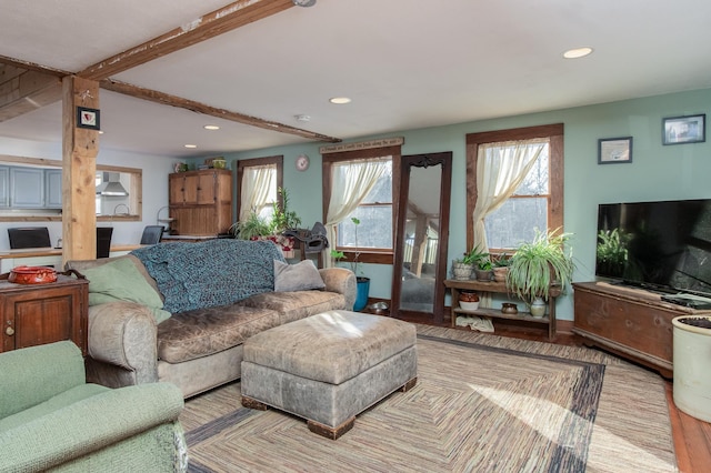 living room featuring beam ceiling and light hardwood / wood-style flooring