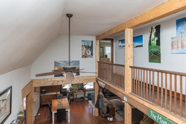 interior space featuring vaulted ceiling and dark wood-type flooring