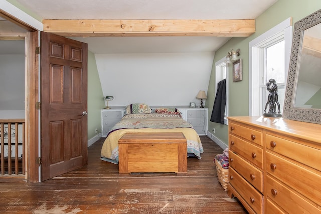 bedroom with beamed ceiling and dark hardwood / wood-style floors