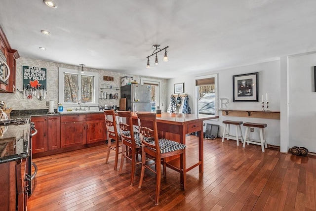 dining room with hardwood / wood-style flooring and sink