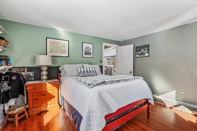 bedroom with wood-type flooring