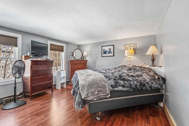 bedroom featuring hardwood / wood-style floors and a textured ceiling