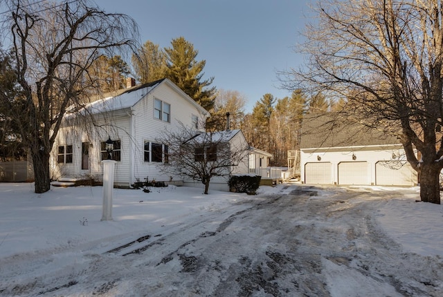 view of snowy exterior featuring a garage