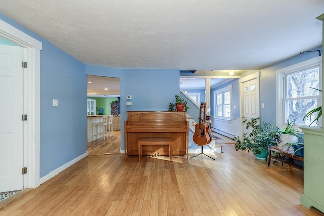 misc room with a baseboard radiator and light wood-type flooring