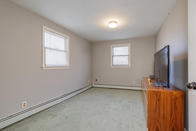 unfurnished living room with a baseboard heating unit and light colored carpet