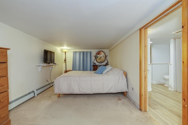 carpeted bedroom with a baseboard heating unit