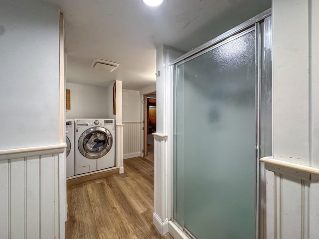 laundry area with light hardwood / wood-style floors and independent washer and dryer