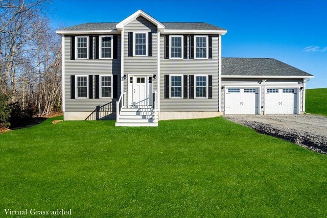 colonial house featuring a garage and a front yard