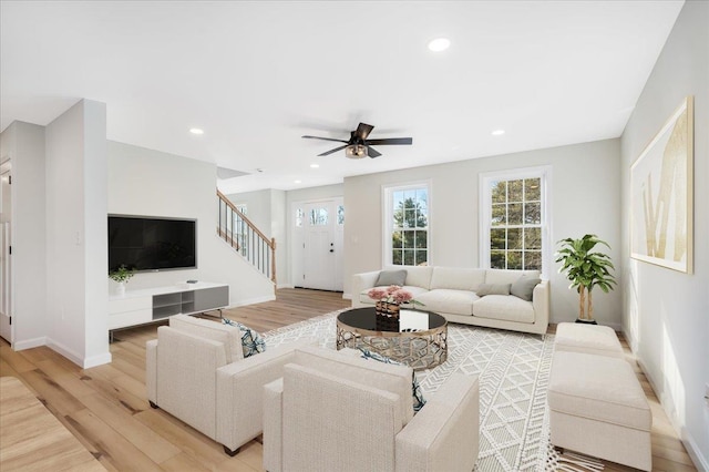 living room with ceiling fan and light wood-type flooring