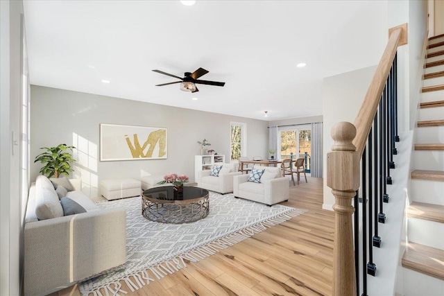 living room featuring hardwood / wood-style floors and ceiling fan