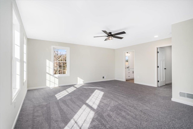 carpeted empty room featuring ceiling fan