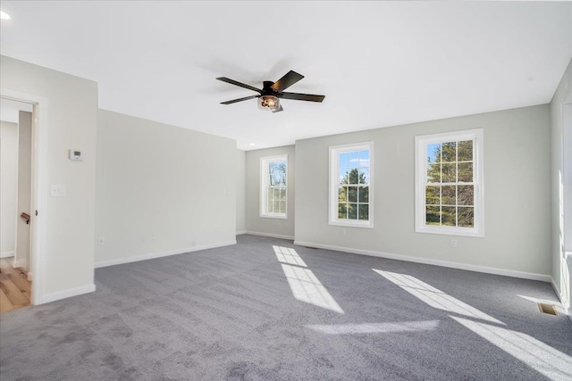 unfurnished room with ceiling fan and carpet flooring