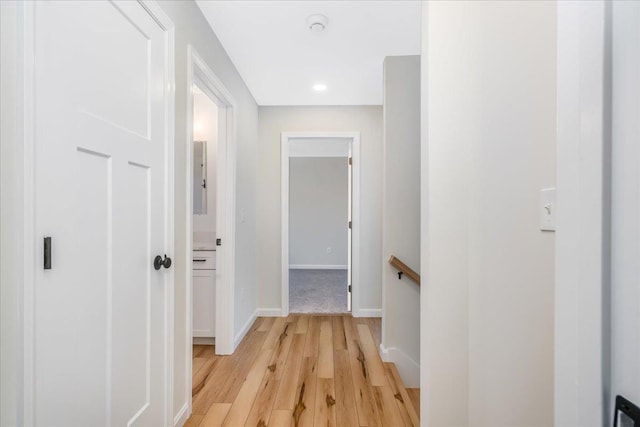 hallway with light hardwood / wood-style floors