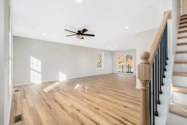 unfurnished living room with ceiling fan and light hardwood / wood-style flooring