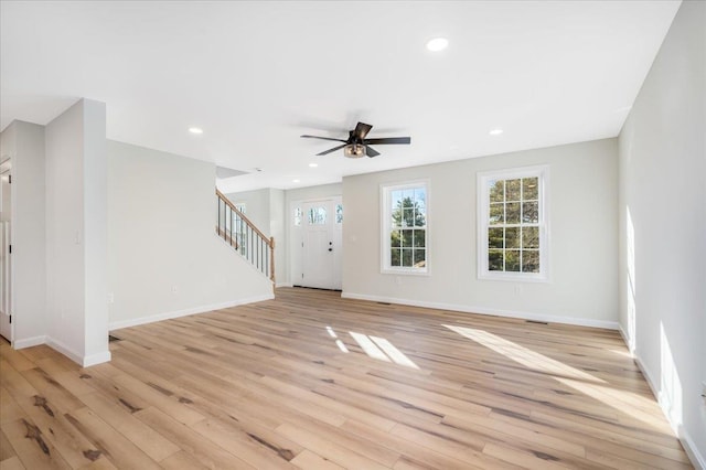 unfurnished living room featuring ceiling fan and light hardwood / wood-style floors