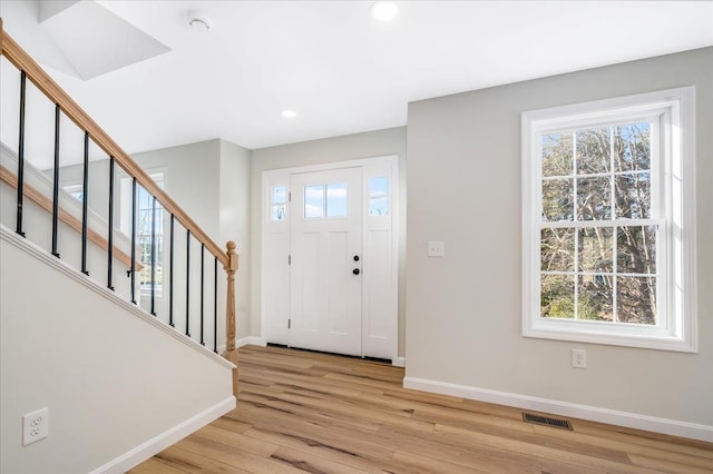 foyer entrance featuring plenty of natural light and light hardwood / wood-style floors