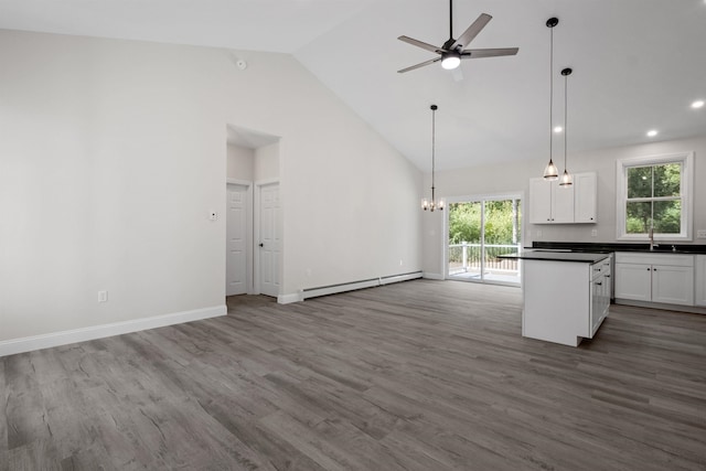 kitchen featuring pendant lighting, white cabinetry, high vaulted ceiling, wood-type flooring, and a baseboard radiator