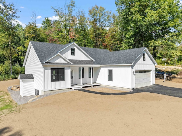 modern farmhouse style home featuring a garage and covered porch