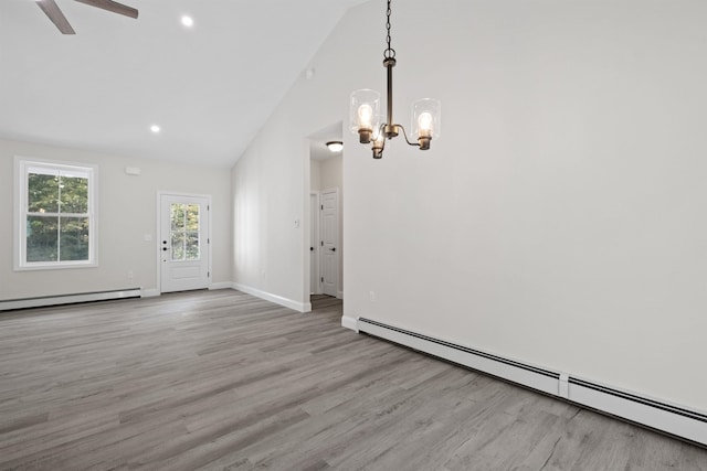 interior space featuring a baseboard radiator, high vaulted ceiling, light hardwood / wood-style floors, and a notable chandelier