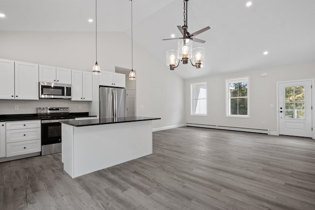 kitchen with white cabinetry, a baseboard heating unit, hanging light fixtures, stainless steel appliances, and a center island