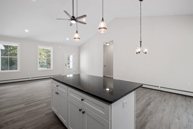 kitchen featuring white cabinetry, pendant lighting, light hardwood / wood-style floors, and a kitchen island