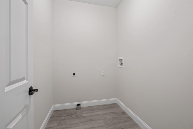 washroom with hookup for an electric dryer, washer hookup, and light hardwood / wood-style flooring