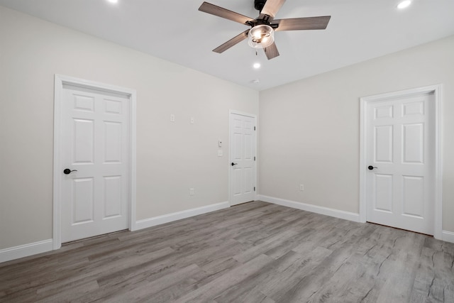 spare room featuring ceiling fan and light wood-type flooring