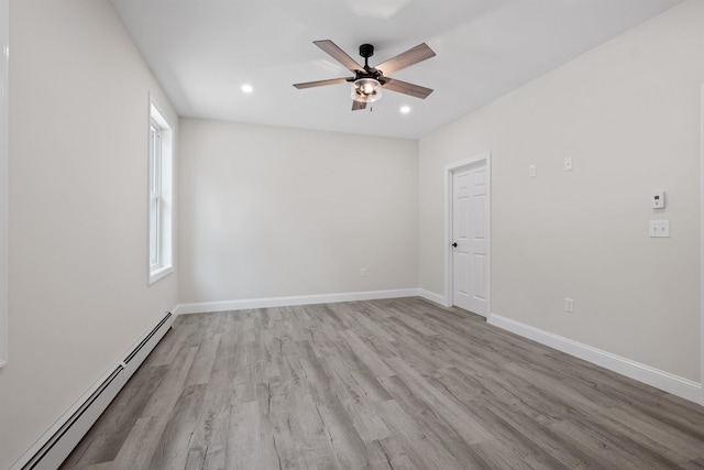 unfurnished room with a baseboard heating unit, light hardwood / wood-style flooring, and ceiling fan