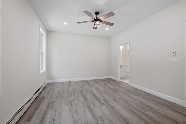 unfurnished room featuring ceiling fan, baseboard heating, and light hardwood / wood-style flooring