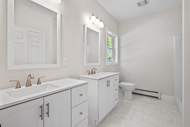 bathroom with a baseboard radiator, vanity, and toilet