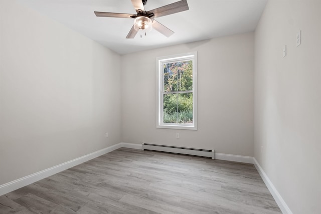 empty room with a baseboard heating unit, ceiling fan, and light hardwood / wood-style flooring