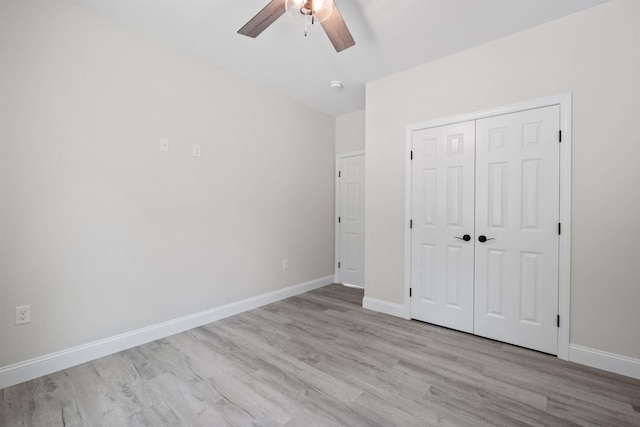 unfurnished bedroom featuring ceiling fan, light wood-type flooring, and a closet