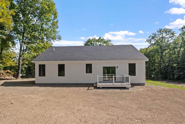 back of house with a deck