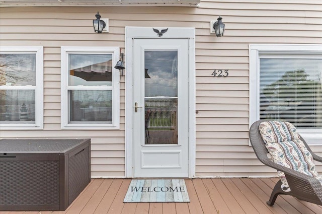 view of exterior entry featuring a wooden deck