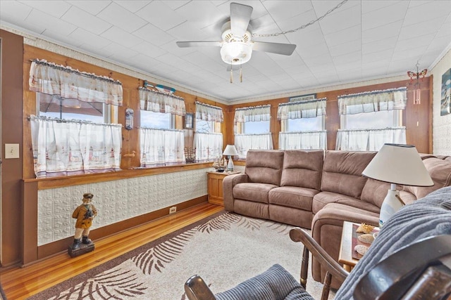 living room with hardwood / wood-style flooring, crown molding, and plenty of natural light