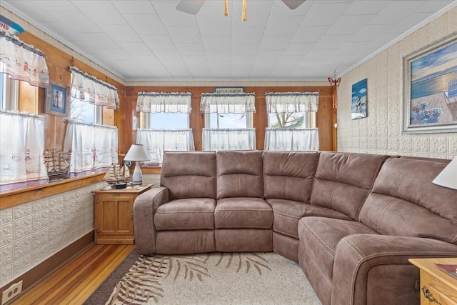 living room featuring crown molding and light hardwood / wood-style floors