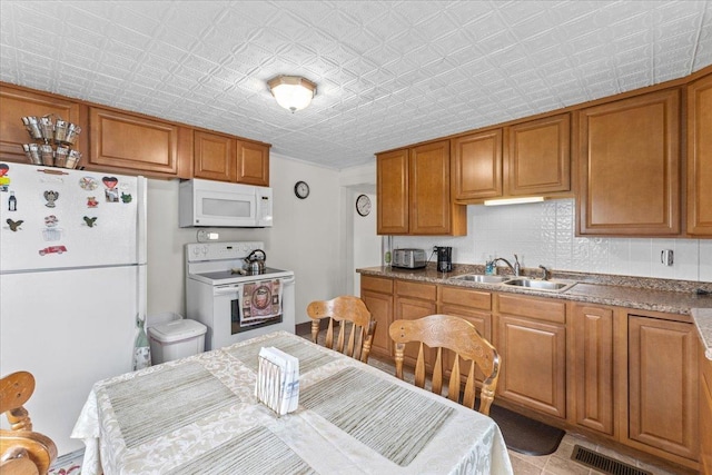 kitchen with sink and white appliances