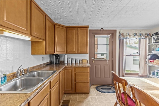 kitchen with tasteful backsplash and sink