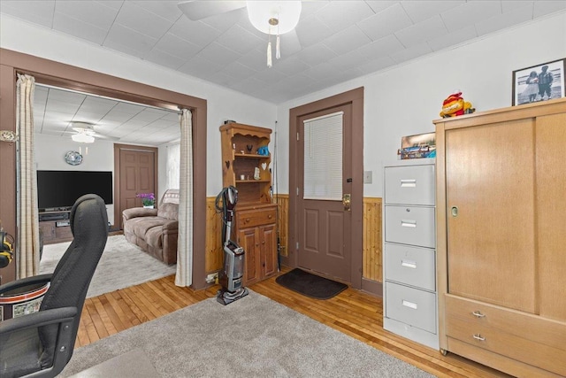 home office with hardwood / wood-style flooring and ceiling fan