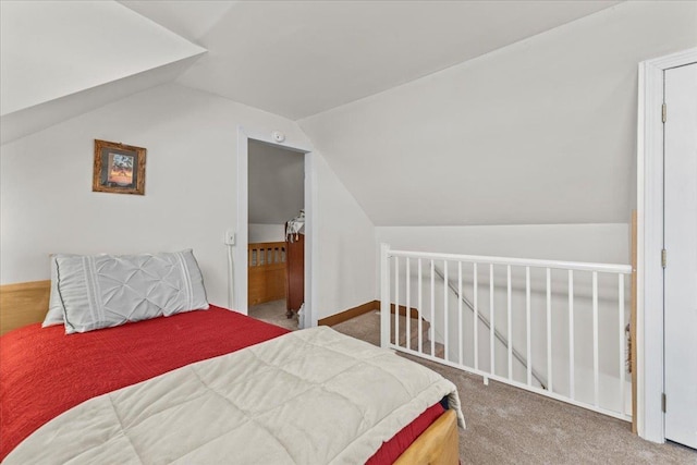 carpeted bedroom with vaulted ceiling