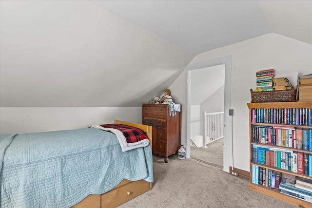 carpeted bedroom with vaulted ceiling