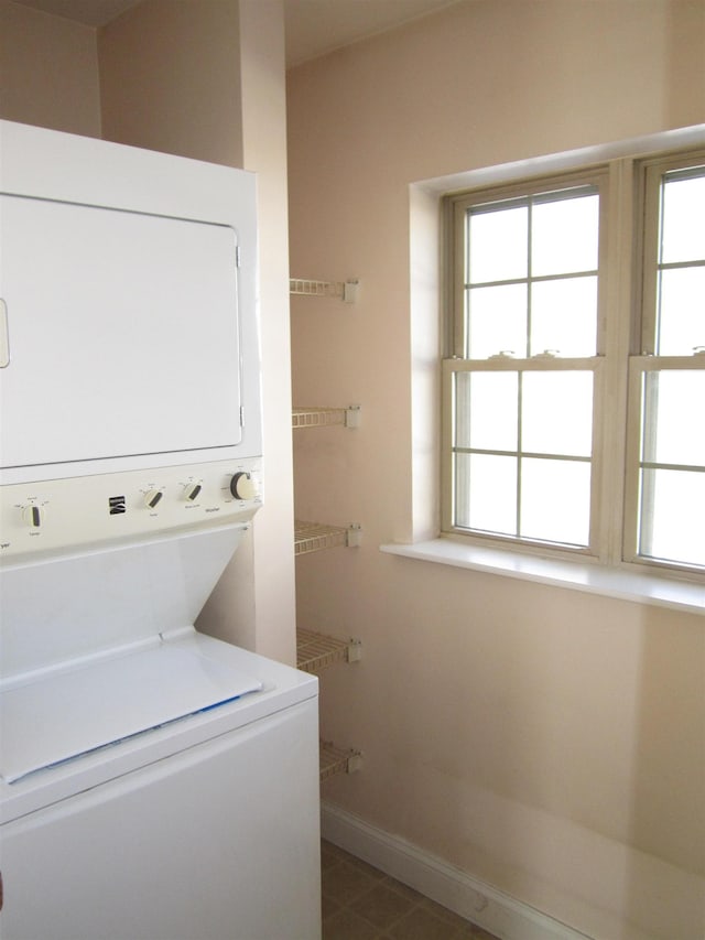 laundry area featuring stacked washer and dryer