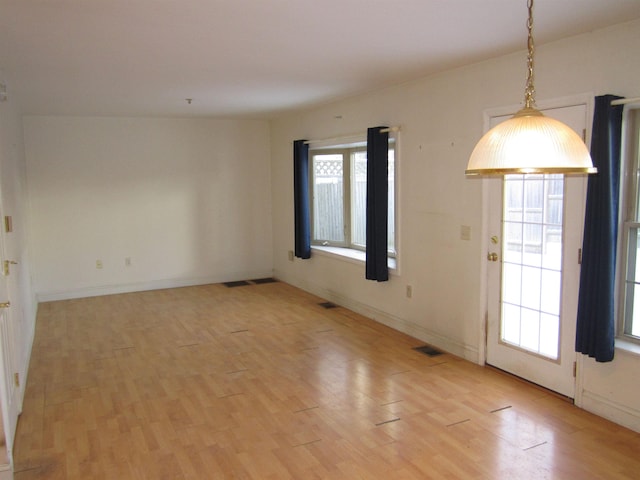 unfurnished room with light wood-type flooring