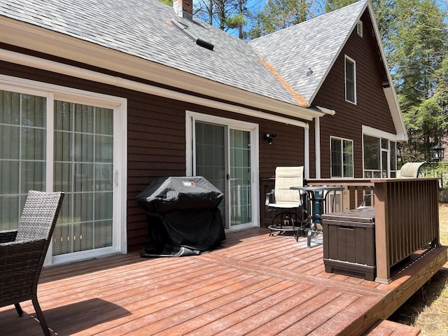 wooden deck featuring a grill