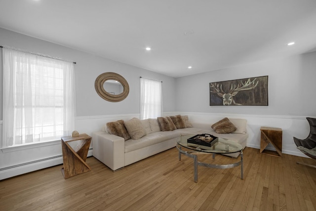 living room with light hardwood / wood-style flooring and baseboard heating