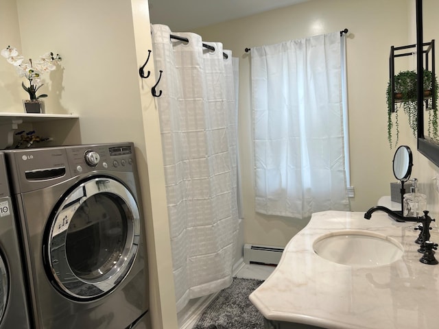 laundry area with washer and clothes dryer, sink, and a baseboard radiator